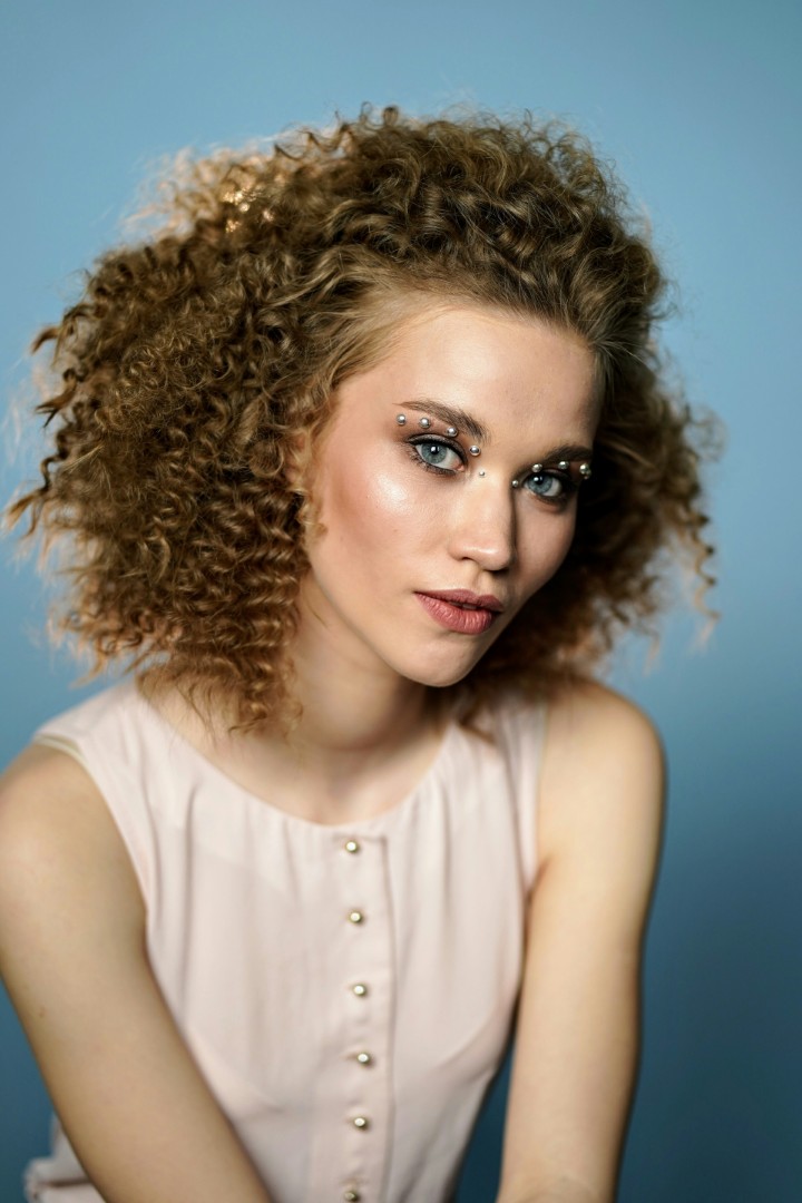a woman with long curly hair
